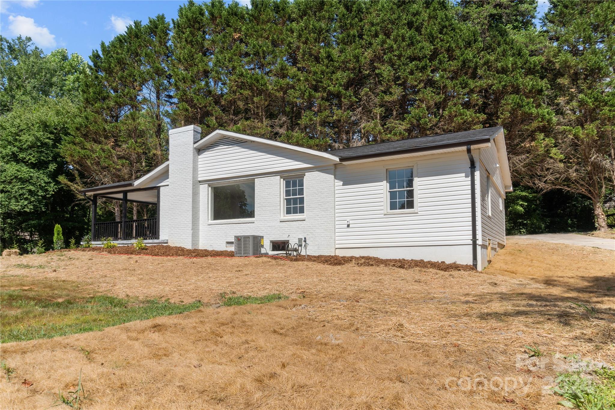 4879 Joe Powell Road Morganton, NC 28655 - Photo 3 of 35 a house with trees in the background