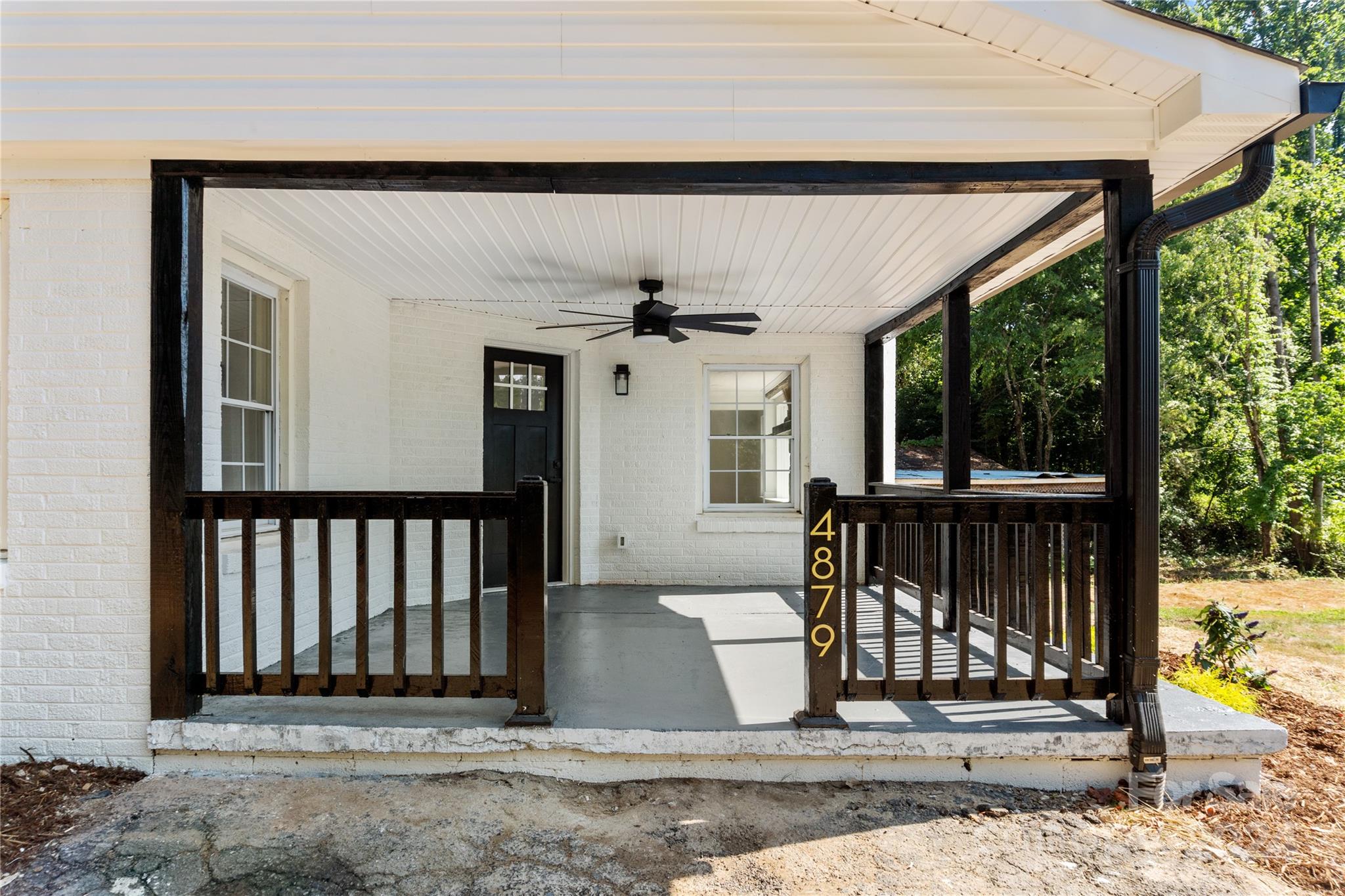 4879 Joe Powell Road Morganton, NC 28655 - Photo 5 of 35 a view of a porch with a floor to ceiling window and yard