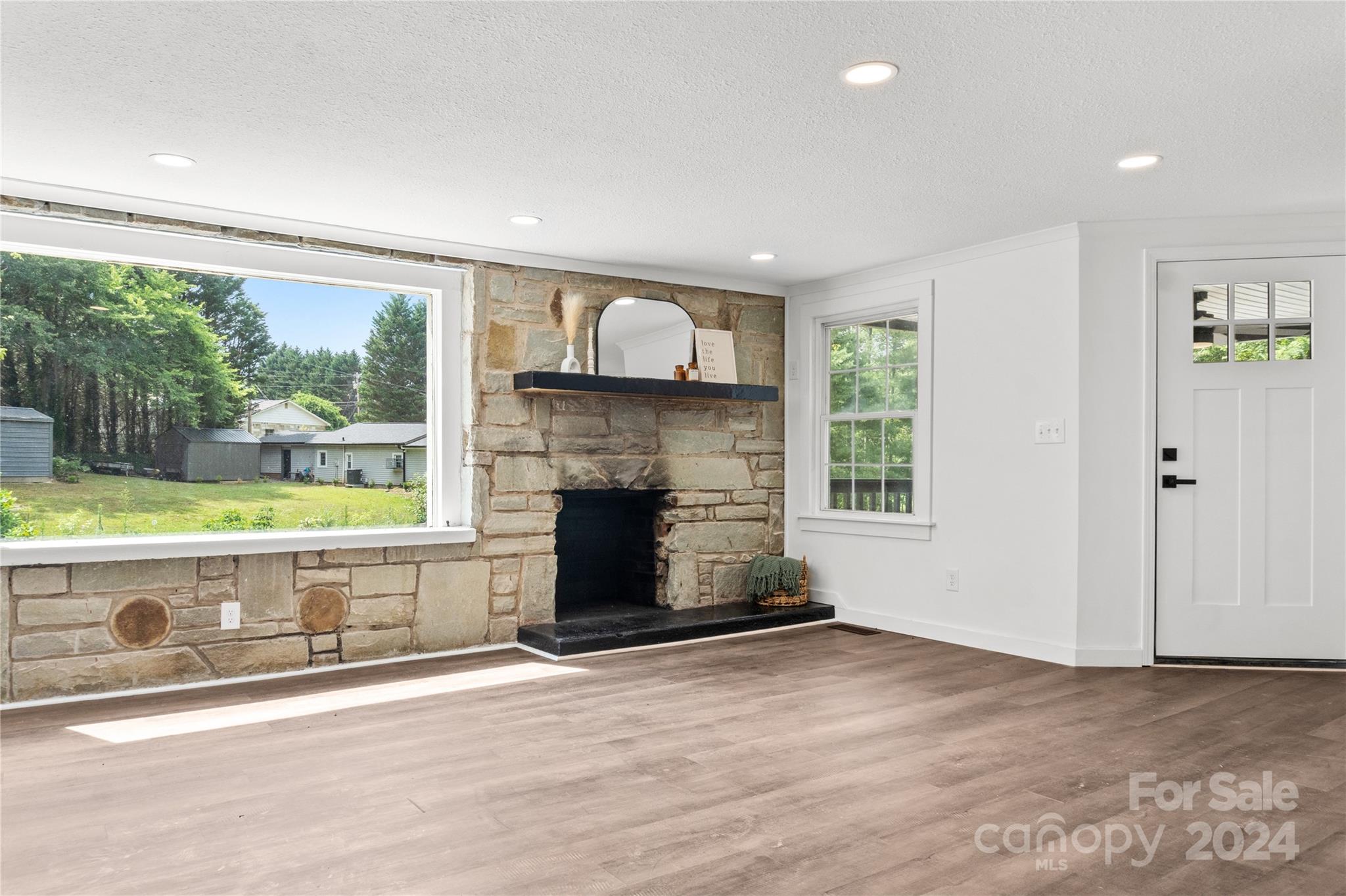 4879 Joe Powell Road Morganton, NC 28655 - Photo 7 of 35 an empty room with windows and fireplace