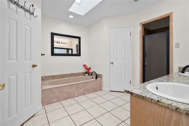 a bathroom with a tub sink and a shower