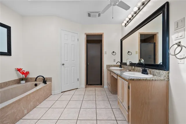 a bathroom with a sink vanity and a mirror