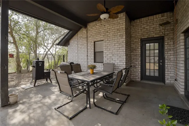 a view of a patio with a table and chairs
