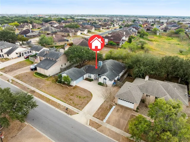an aerial view of residential house with an outdoor space