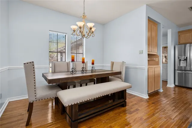 a living room with a bed and a chandelier