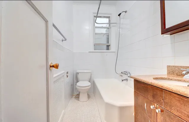 a white toilet sitting next to a bathroom sink