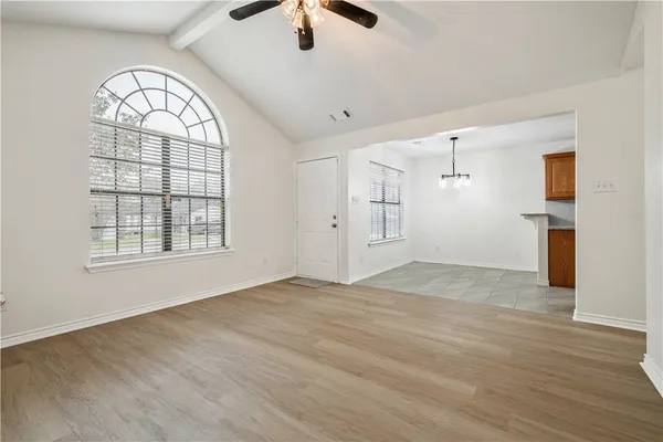 wooden floor in an empty room with a window