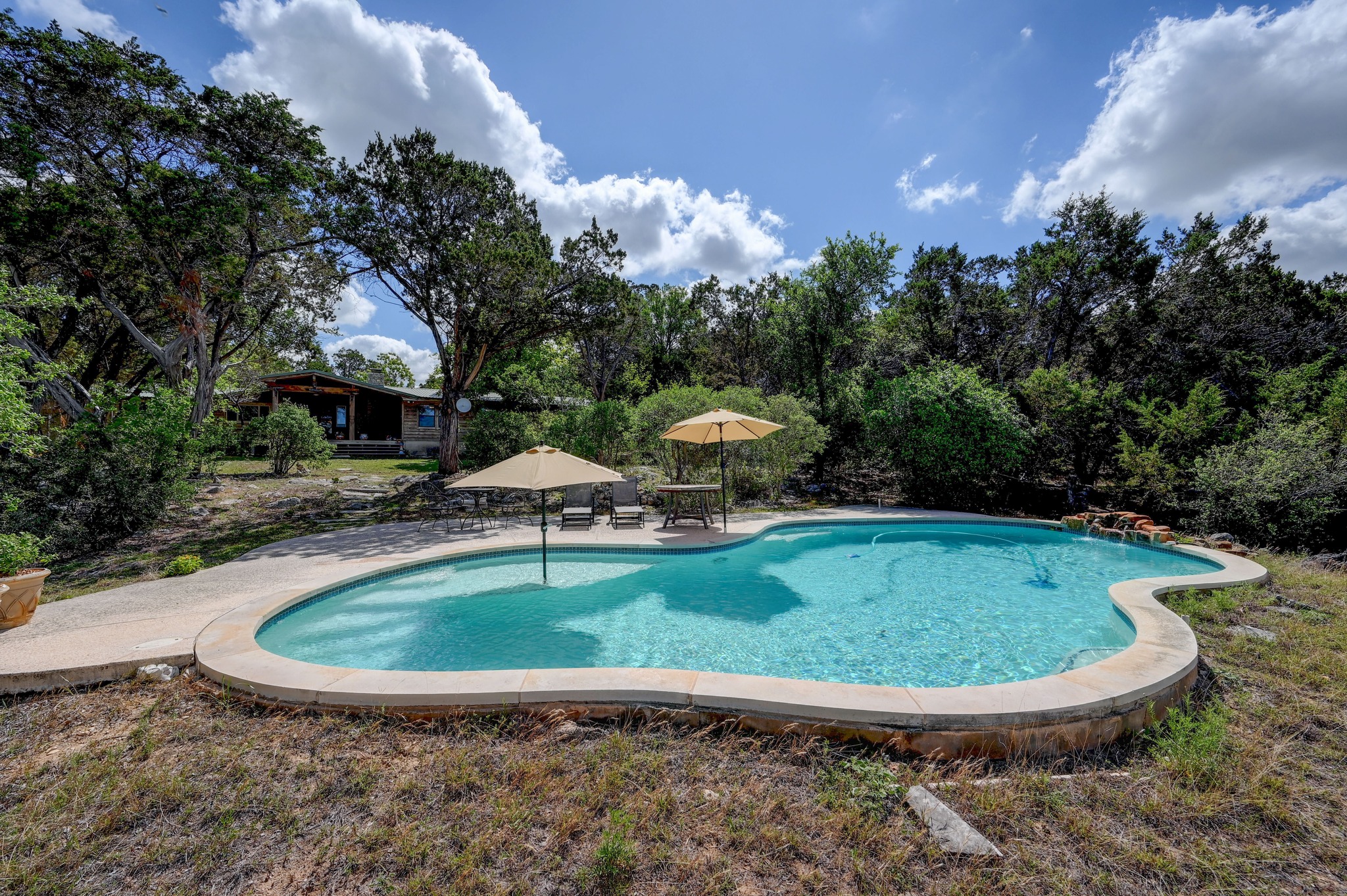 900 Box Canyon Road Wimberley, TX 78676 - Photo 36 of 40 Looking back at the house from the pool area.