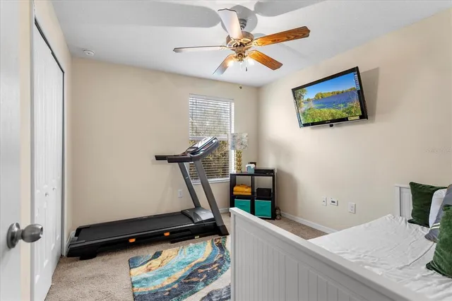 a room with gym equipment and a flat screen tv
