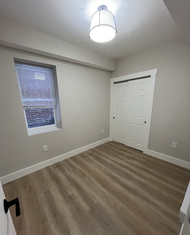 17 M Street Boston, MA 02127 - Photo 5 of 10 a view of an empty room with a window and wooden floor