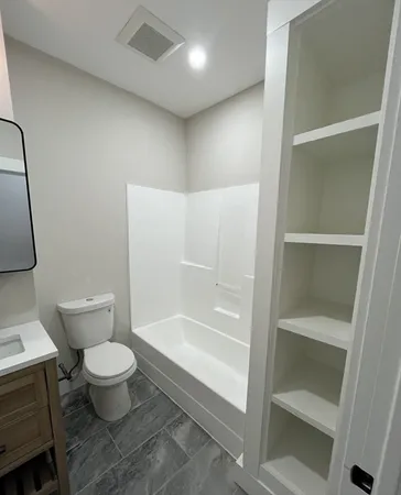 a bathroom with a toilet and a shower