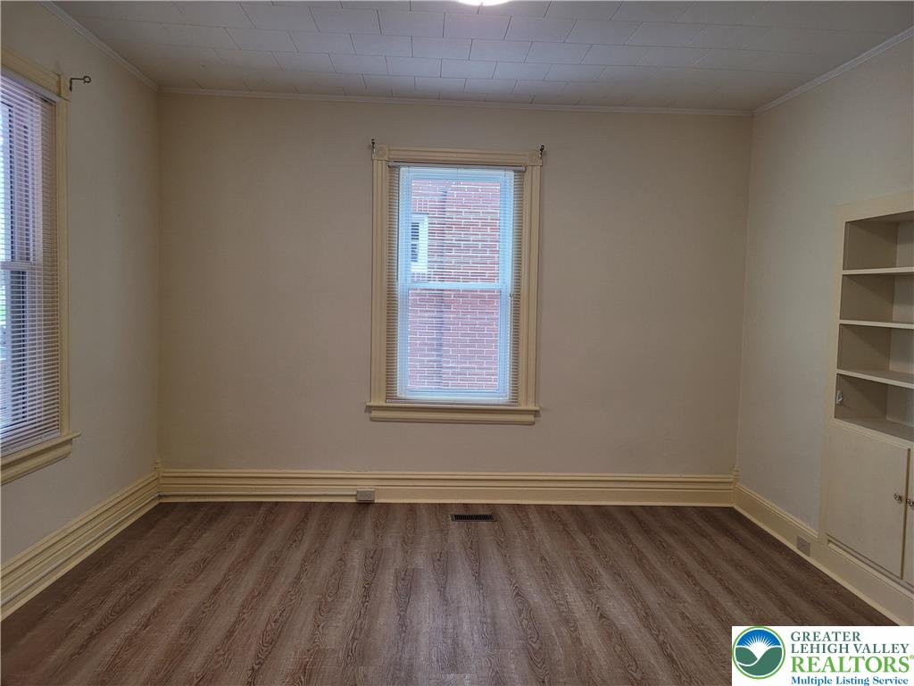 1024 Delaware Avenue, Unit 1 Bethlehem, PA 18015 - Photo 9 of 17 a view of an empty room with wooden floor and a window