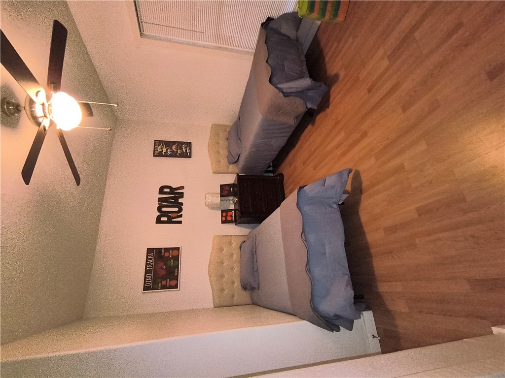 611 Wheelock Street Franklin, TX 77856 - Photo 4 of 8 a spacious bedroom with a bed and a chandelier