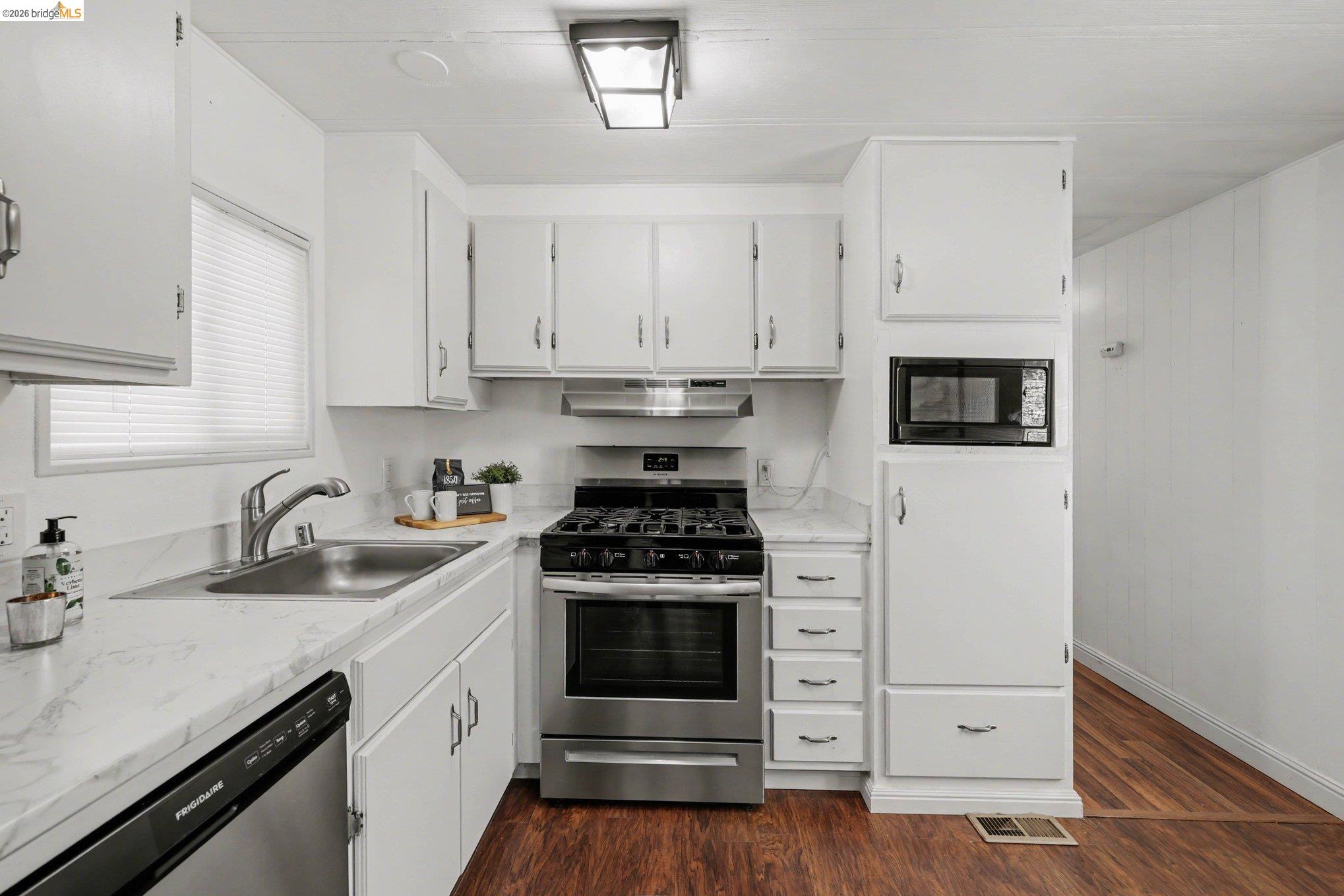 36 Cayuga Street Oakley, CA 94561 - Photo 10 of 25 Kitchen with light countertops, stainless steel appliances, white cabinets, and dark wood finished floors