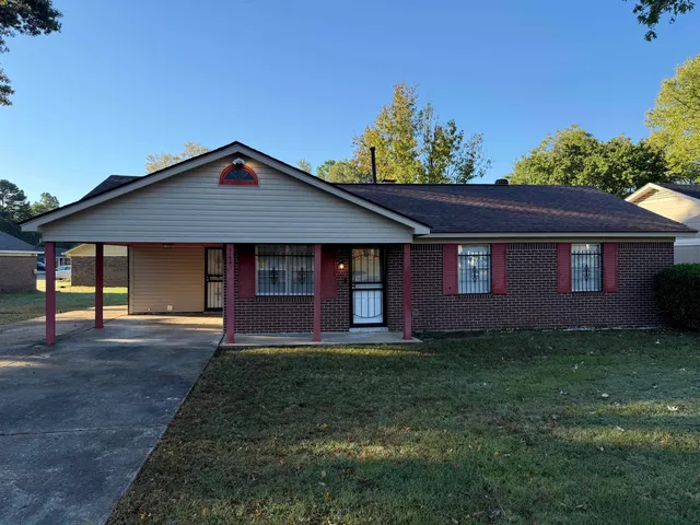 a front view of a house with a garden