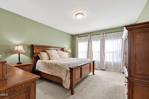 a bedroom with a bed and a night stand