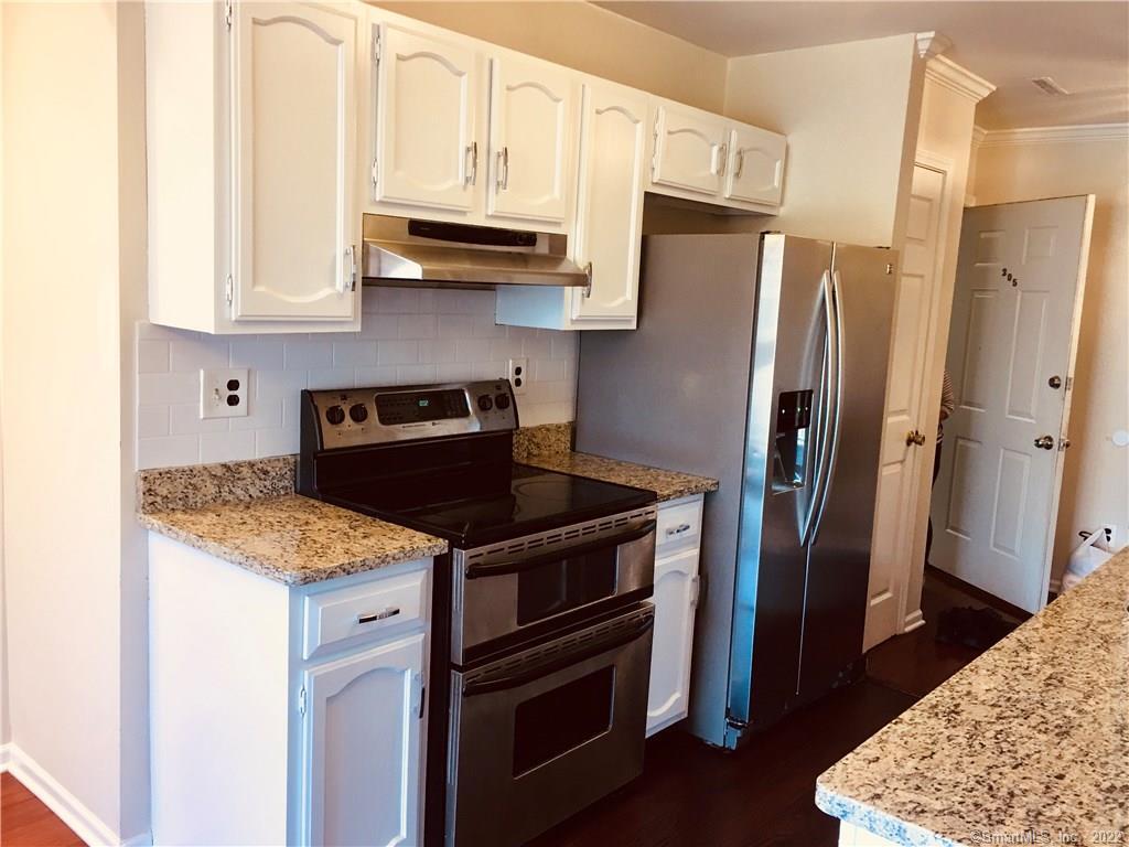 1 Valley Road, Unit 205 Stamford, CT 06902 - Photo 1 of 1 a kitchen with stainless steel appliances granite countertop a refrigerator and a stove