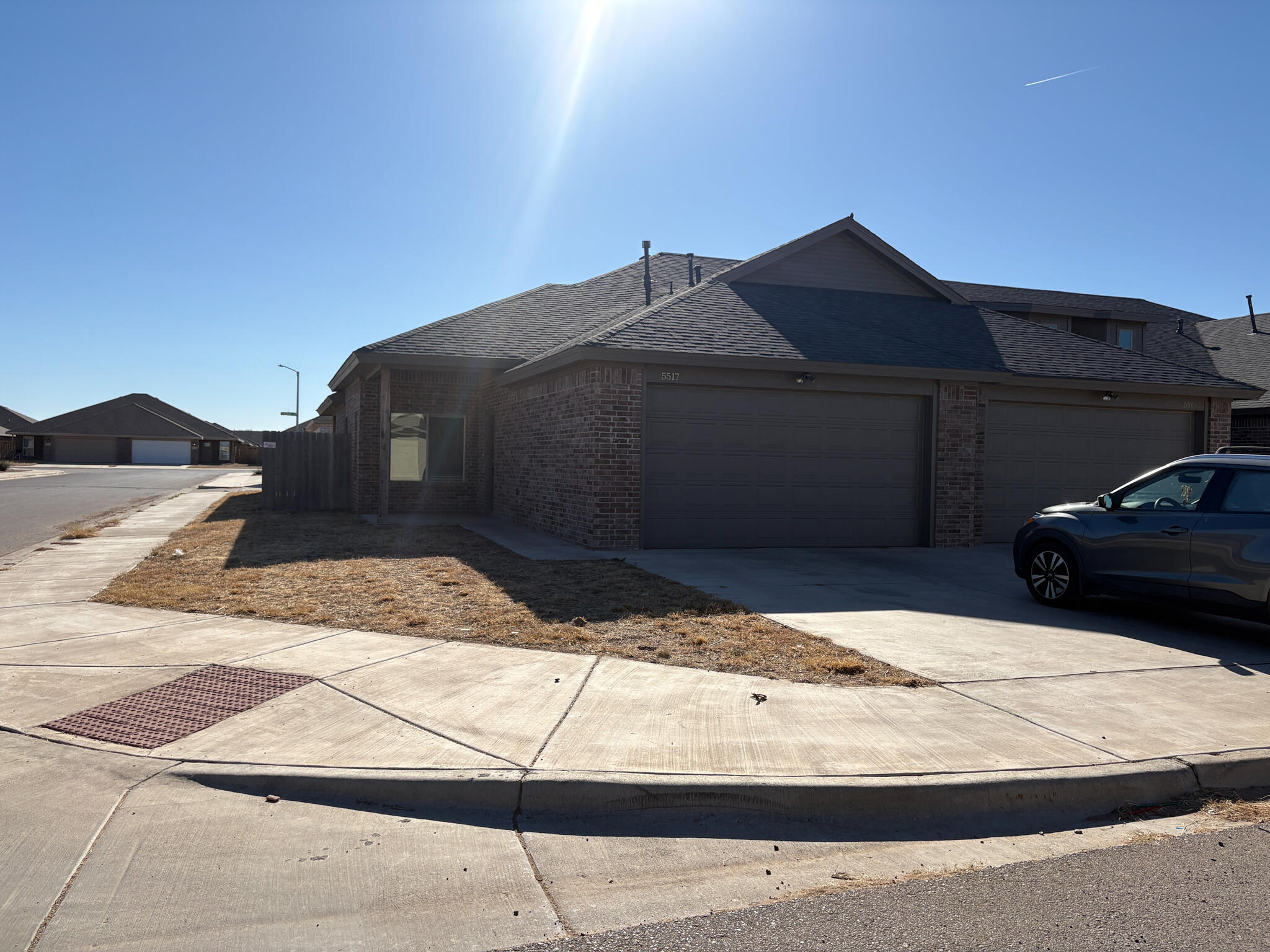 a black car parked in front of a house