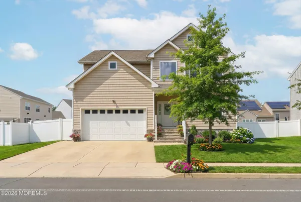 a view of a house with a yard and garage