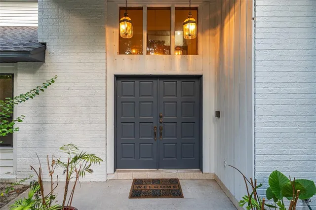an empty room with windows and a ceiling fan