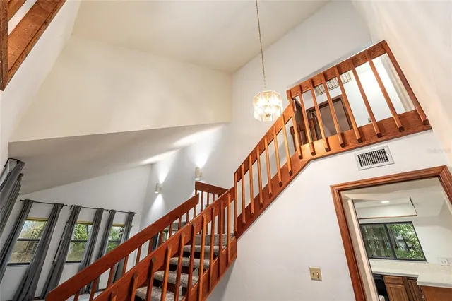 a living room with a large window and furniture