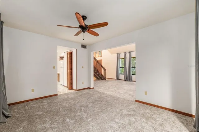 a bathroom with a granite countertop toilet sink and mirror
