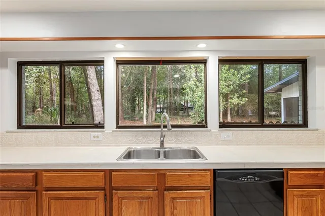 a bathroom with a granite countertop sink a toilet and shower
