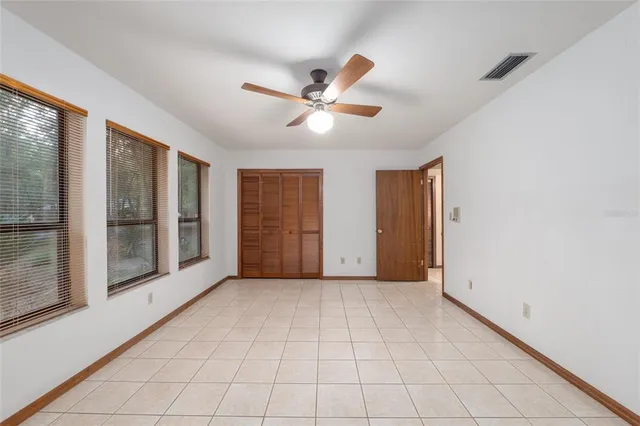 an aerial view of a house with a yard and swimming pool