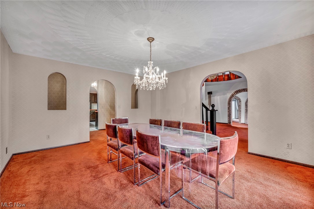 230 Crosse Road Amherst, OH 44001 - Photo 24 of 47 Carpeted dining area featuring a chandelier