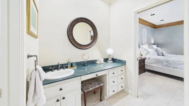 a bathroom with a granite countertop sink and a mirror
