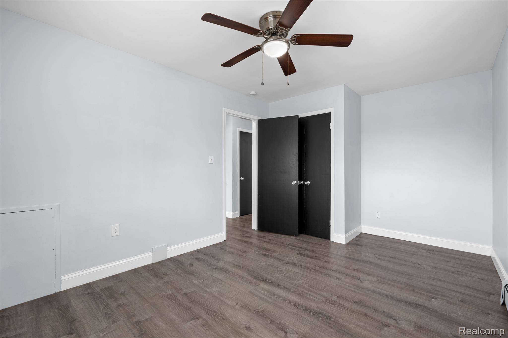 3931 Devon Road Royal Oak, MI 48073 - Photo 10 of 11 Unfurnished bedroom featuring ceiling fan and dark wood-style flooring