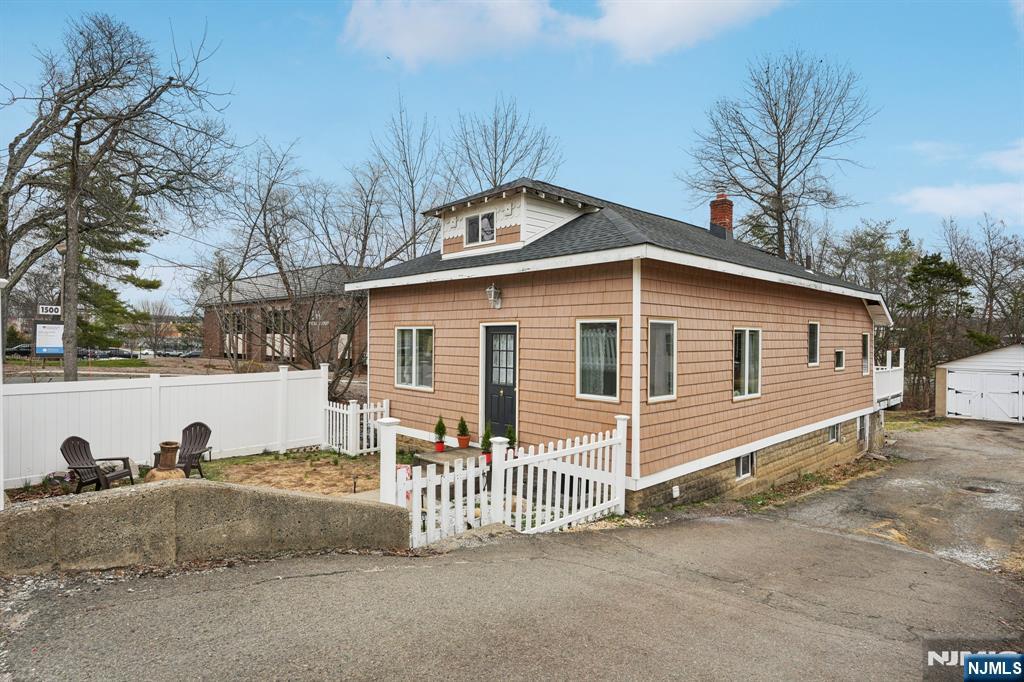 a view of a house with a wooden fence