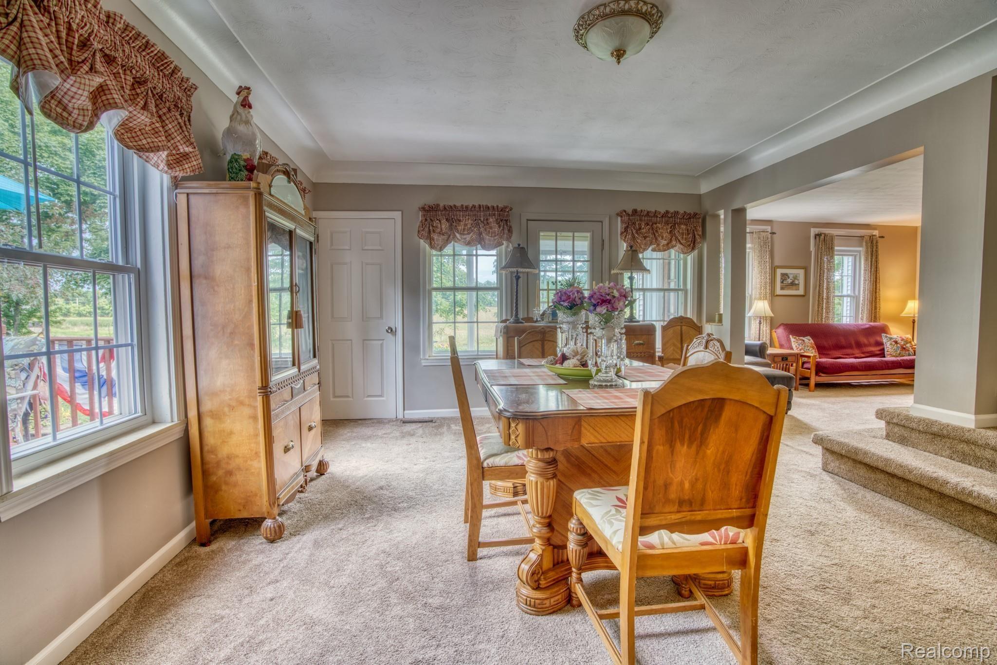4065 Jewell Road Howell, MI 48843 - Photo 5 of 62 DINING ROOM. WINDOWS YOU ARE SEEING ARE ORIGINAL GLASS BLOWN. DOOR LEADS TO ENCLOSED PORCH AREA
