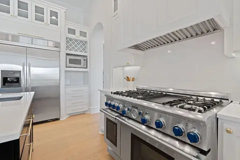 a stove top oven sitting inside of a kitchen