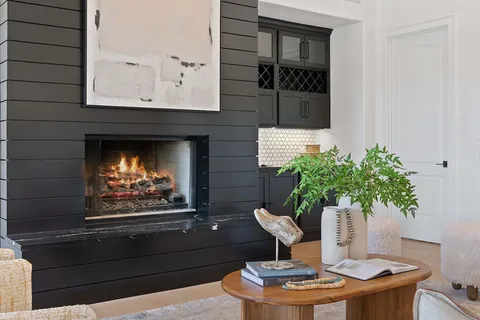a vase of flowers sitting on a table in front of a window