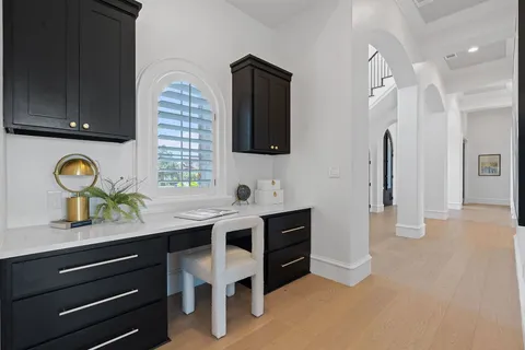 a room with a table chairs and entryway