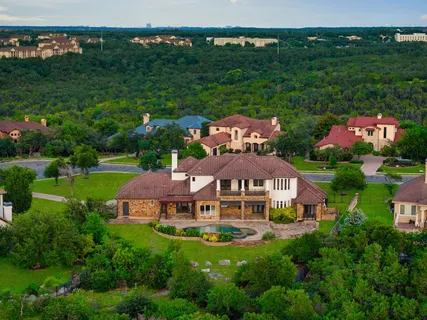 an aerial view of a house with garden space lake view and yard