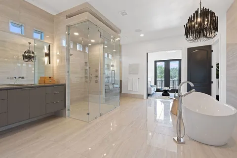 a large bathroom with a sink a mirror a bathtub and shower