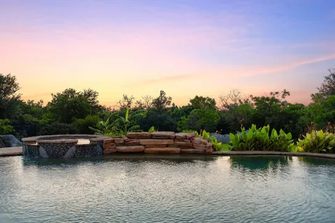 a view of house with outdoor space and lake view