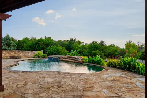 a view of a swimming pool with a yard