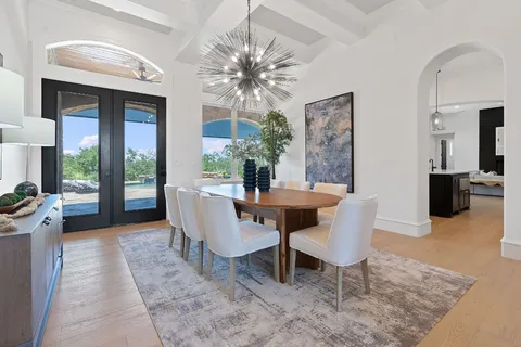 a dining room with furniture a rug and a chandelier