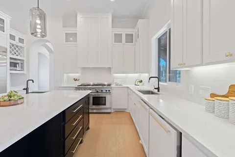 a kitchen with a sink stove and cabinets