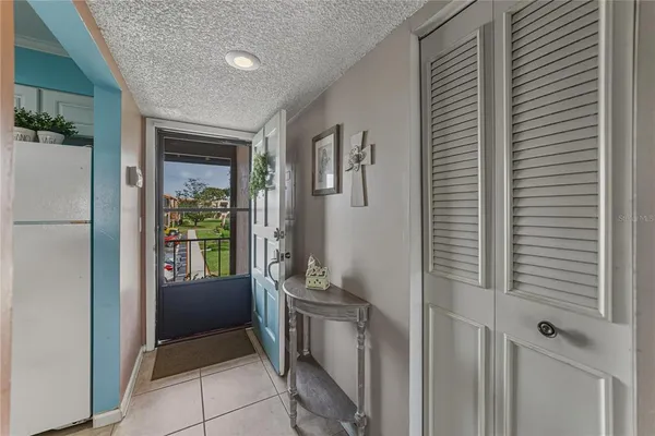a room with window and a refrigerator