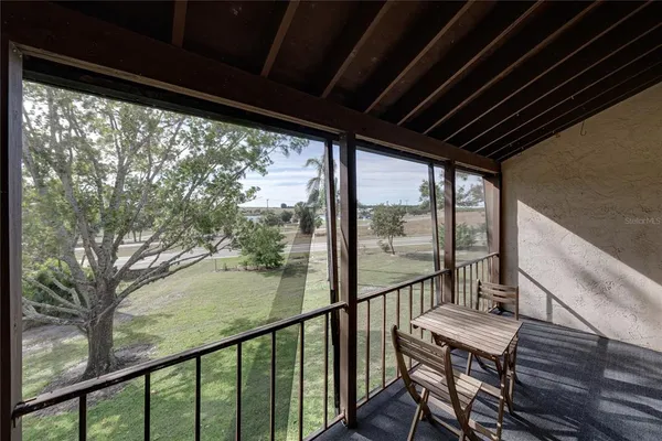 a view of a city from a balcony with furniture