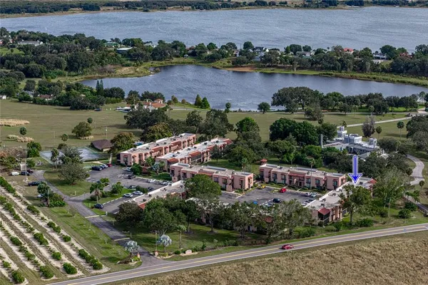an aerial view of a house with outdoor space and lake view