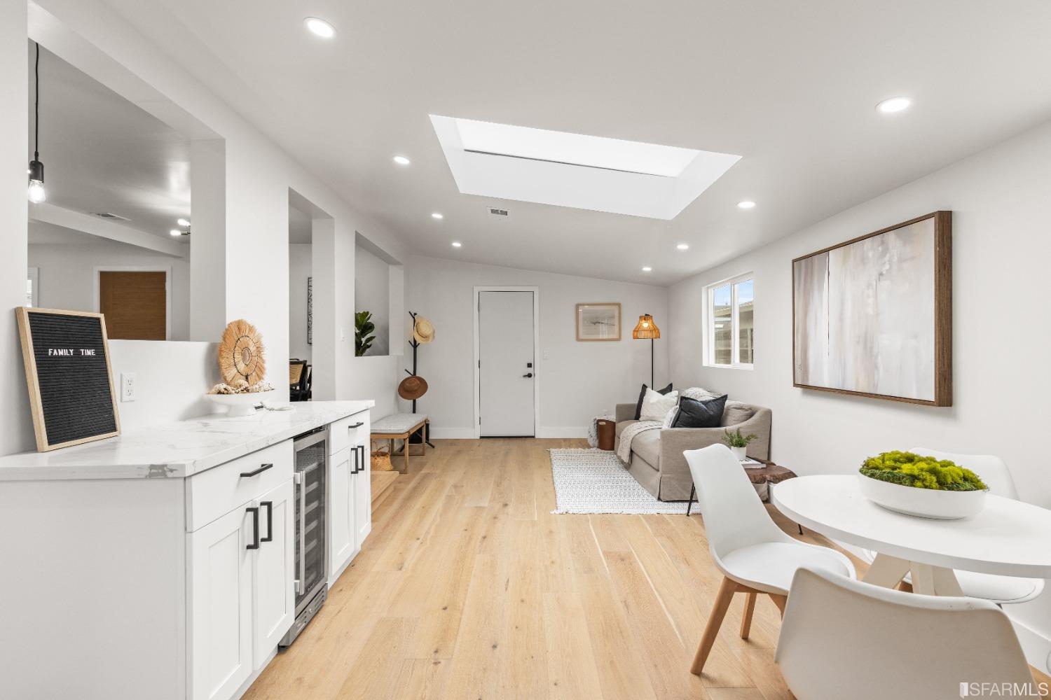1139 Peralta Road Pacifica, CA 94044 - Photo 13 of 58 a living room with kitchen island furniture a chandelier a sink and a window