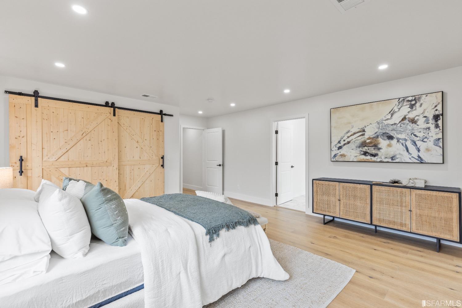1139 Peralta Road Pacifica, CA 94044 - Photo 20 of 58 a spacious bedroom with a large bed a rug and painting on the wall