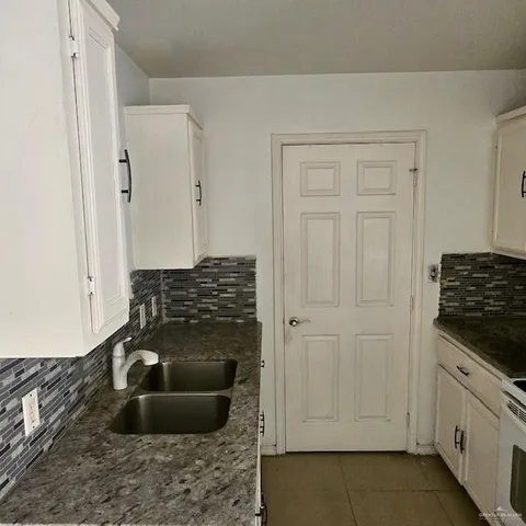 a kitchen with a stove and a sink