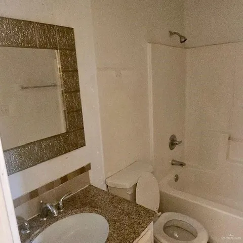 a bathroom with a sink a toilet and bathtub