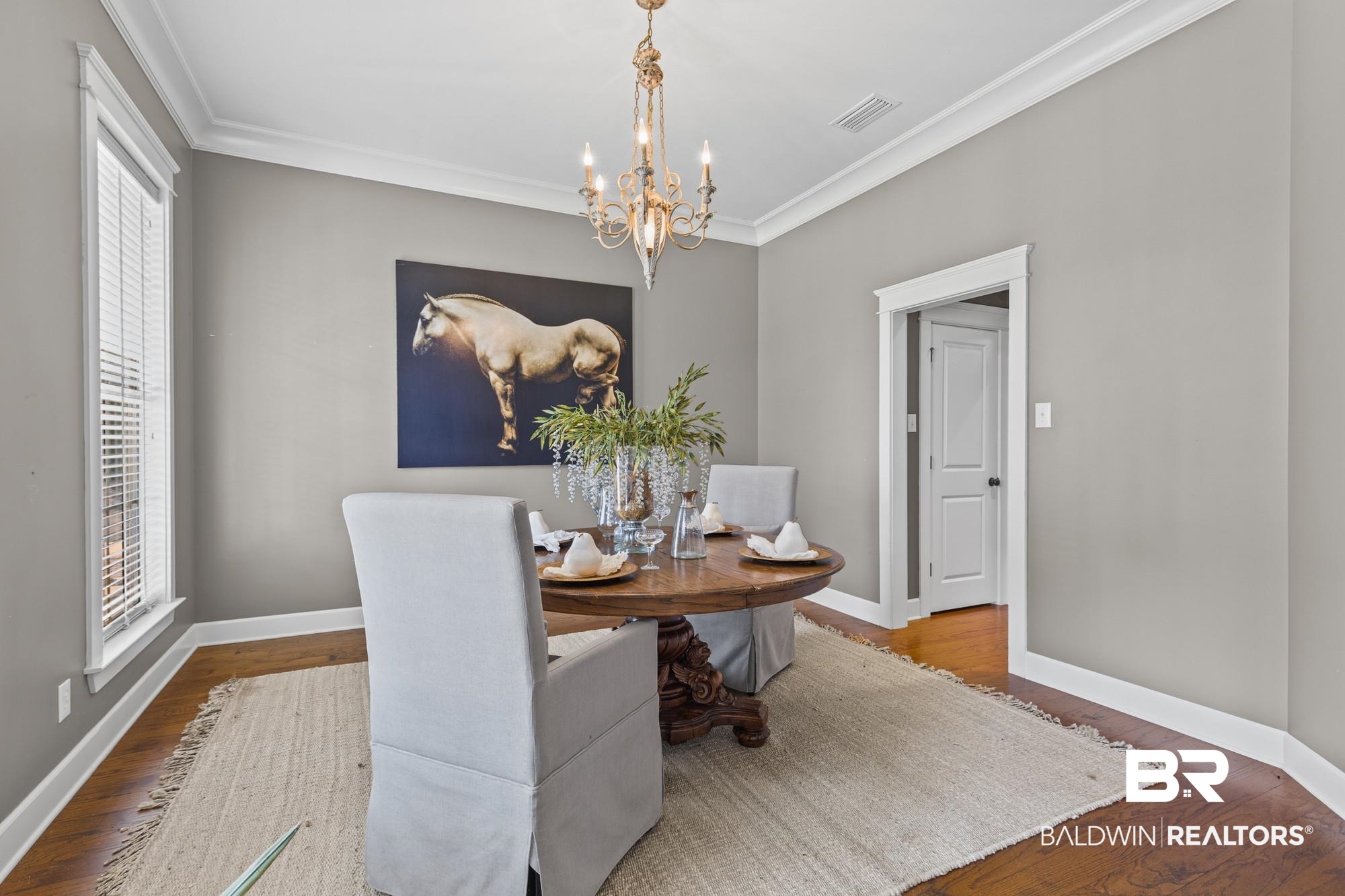 11261 Halcyon Loop Daphne, AL 36526 - Photo 13 of 41 Room featuring rich wood-finish flooring, light gray walls, and white crown molding