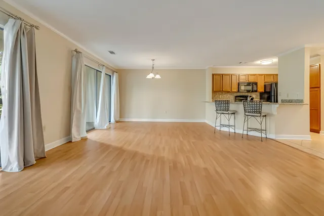 a view of a livingroom with a ceiling fan and window